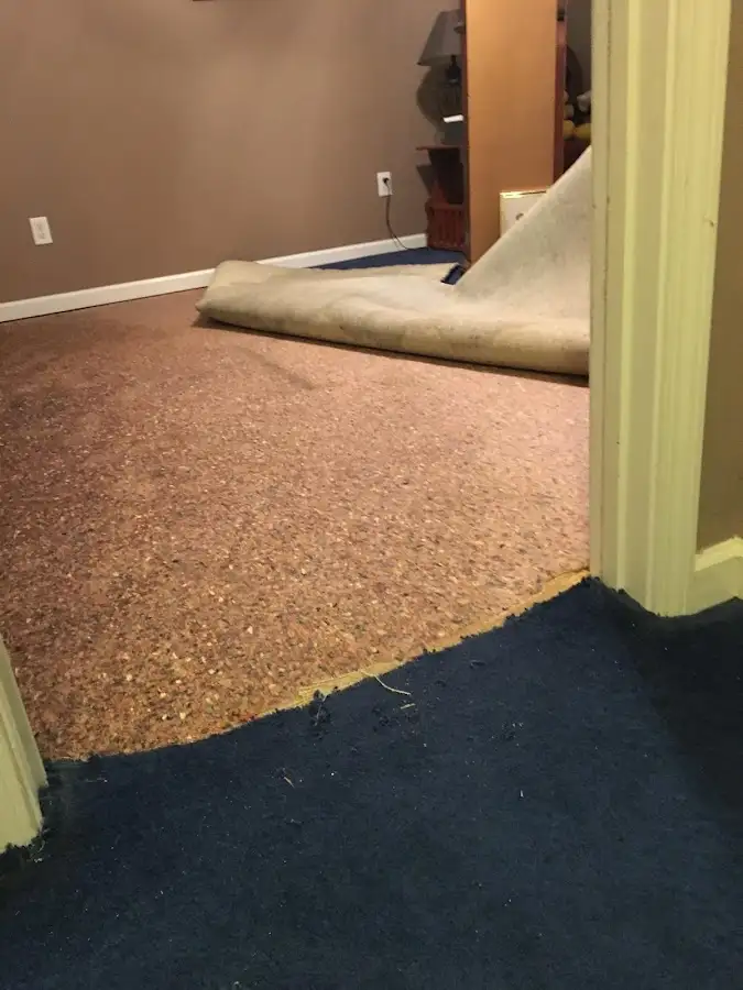 Carpet pad removal revealing water damage during Drying & Dehumidification in Ogdensburg